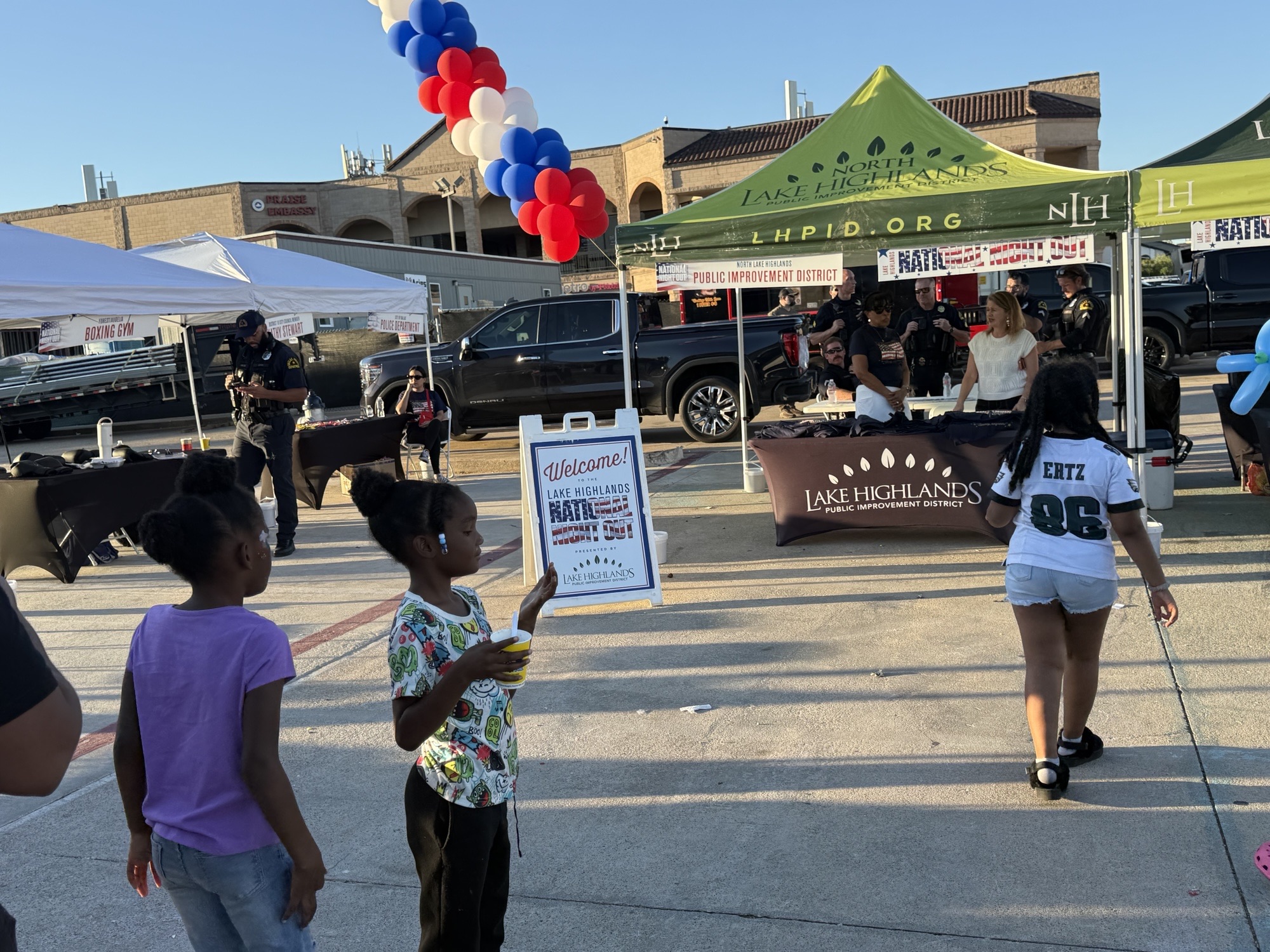 Families visit the Lake Highlands information tent at National Night Out.